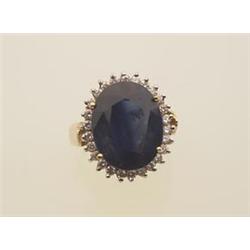 sapphire and diamond cluster ring The ring is in 14K yellow gold, featuring an 8.50 oval facetted...