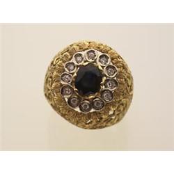 sapphire, diamond and gold ring The pierced, engraved 18K yellow gold domed setting is surmounted...
