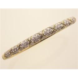 Diamond and gold bangle bracelet The 18K yellow and white gold bracelet is set with one hundred f...