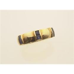 gold and sapphire band style ring In 18K yellow gold, the domed tapering band is set with six 2 m...