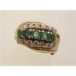 fancy emerald and diamond ring The custom made 18K yellow gold ring is a fluted domed design set...