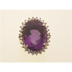 amethyst and diamond cluster ring In 14K yellow and white gold, an oval facetted amethyst weighin...