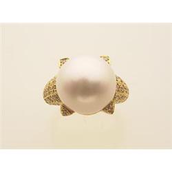 south sea pearl, diamond and gold ring The 18K yellow gold setting has pave set diamond shoulders...