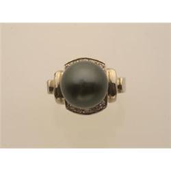 black south sea pearl ring In 14K white gold, the setting features a 13 mm. off round natural bla...