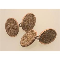 Edwardian gold cufflinks In 9K rose gold, the double faced design is of oval plaques engraved wit...