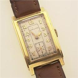 GENTLEMAN'S HAMILTON WRISTWATCH 14K yellow gold curved rectangular tank case, white dial with Ara...