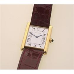 cartier wristwatch The mid-size tank Louis Cartier has an 18K yellow gold case numbered 960664831...