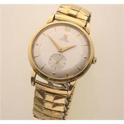 gentleman's omega automatic wristwatch Having an 18K gold round case, a silvered dial with gold b...