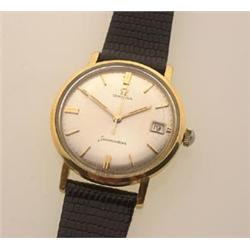 gentleman's omega seamaster wristwatch Having an 18K gold round case, a silvered dial with gold b...