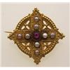 Image 1 : antique gold, ruby and pearl brooch In 18K yellow gold with a Roman finish, the pierced round bro...