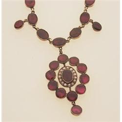 early Victorian garnet and seed pearl necklace The necklace is comprised of a chain of thirty-nin...