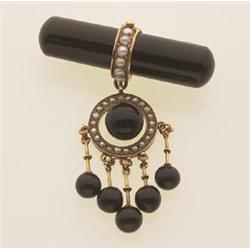 vintage onyx, pearl and gold brooch A 1 3/4 in. (4.4 cm.) tubular onyx bar has a half pearl set g...