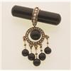 Image 1 : vintage onyx, pearl and gold brooch A 1 3/4 in. (4.4 cm.) tubular onyx bar has a half pearl set g...