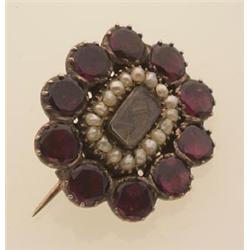 early Victorian garnet and seed pearl sentimental brooch In low karat gold, a frame of ten collet...