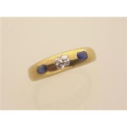 gold, diamond and sapphire band style ring An 18K yellow gold domed band is set with one .20 cara...