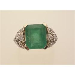 fancy emerald and diamond ring A 14K white gold setting features an emerald cut emerald weighing...