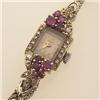 Image 1 : lady's wristwatch in diamonds, rubies and gold The bracelet and rectangular outer case is in 14K...