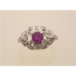 ruby and diamond ring In 14K white gold, a .66 carat round facetted ruby surmounts an openwork ov...