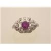 Image 1 : ruby and diamond ring In 14K white gold, a .66 carat round facetted ruby surmounts an openwork ov...