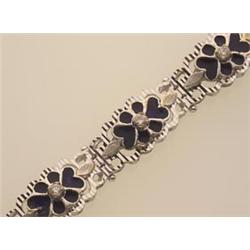 gold, enamel and diamond bracelet In 18K white gold, the ribbed openwork flower motif links have...