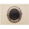 Image 1 : star sapphire and diamond cluster ring An 18K white gold setting contains an oval blue star sapph...