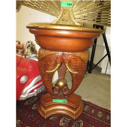 Carved wood table with elephant heads in base