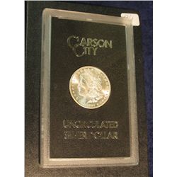 1597. 1884 CC Morgan Silver Dollar in original black box of issue with official card. MS 63/64.