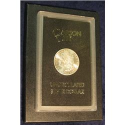 1598. 1884 CC Morgan Silver Dollar in original black box of issue with official card. MS 63.