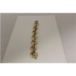 ONE 14KT YELLOW GOLD AND WHITE GOLD ITALIAN MADE MODERN LINK STYLE BRACELET. THE BRACELET WEIGHS