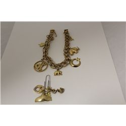 ONE 10KT YELLOW GOLD CHARM BRACELET. MADE IN A CONTEMPORARY DESIGN, INCLUDES 11 CHARMS 10KT AND