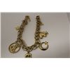 Image 2 : ONE 10KT YELLOW GOLD CHARM BRACELET. MADE IN A CONTEMPORARY DESIGN, INCLUDES 11 CHARMS 10KT AND