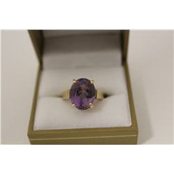 ONE LADIES 10KT YELLOW GOLD NATURAL AMETHYST RING. SET WITH 1 OVAL MIXED CUT NATURAL AMETHYST 7.45