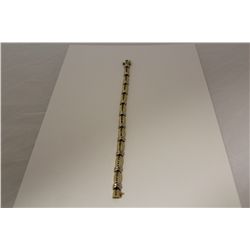 ONE 14KT YELLOW GOLD AND WHITE GOLD DIAMOND LINE DESIGN BRACELET. THE BRACELET IS CHANNEL SET WITH