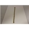 Image 1 : ONE 14KT YELLOW GOLD AND WHITE GOLD DIAMOND LINE DESIGN BRACELET. THE BRACELET IS CHANNEL SET WITH