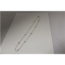 ONE 10KT YELLOW GOLD AND COLOURLESS CUBIC ZIRCONIA CHOKER LENGTH NECKLACE. THE NECKLACE IS MARKED