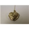 Image 1 : ONE 10KT YELLOW GOLD HEAR SHAPED LOCKET PENDANT AND 10KT YELLOW GOLD CHAIN.