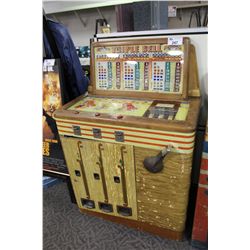 BALDY SEMI-ELECTRICAL TRIPLE BELL SLOT MACHINE IN WORKING ORDER. ACCEPTS 5, 10 AND 25 CENT PIECES