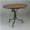 Image 1 : Rare MORGAN COLT circular wrought-iron table, the top covered in linen with a punched copper meda...