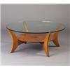 Image 1 : Fine VLADIMIR KAGAN cherry coffee table with a circular plate glass top inset on curved legs join...