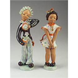 Pair of GOLDSCHEIDER figurines of a boy and girl, in polychrome glazes. Restoration to boy in sev...