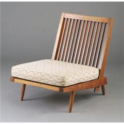 GEORGE NAKASHIMA walnut lounge chair with spindle back and brocade upholstered loose cushions. (P...