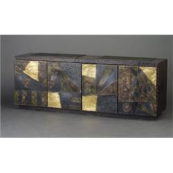 PAUL EVANS credenza, 1972, with two-part inset slate top and four doors sculpted with an abstract...