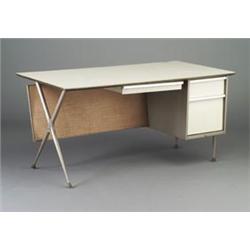 RAYMOND LOEWY desk with gray formica top, pegboard back and three white enameled drawers, on alum...