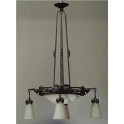 French Art Deco hand-hammered iron chandelier, c. 1926, with frosted glass dome and four pendant...