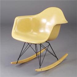 CHARLES EAMES for HERMAN MILLER fiberglass shell armrocker with ochre shell, birch runners, and b...