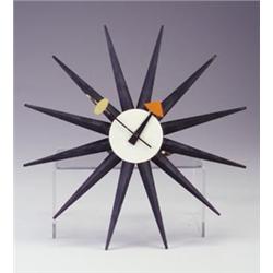 HOWARD MILLER "Starburst Clock" with black rays, white face, and black hands terminating in orang...