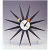 Image 1 : HOWARD MILLER "Starburst Clock" with black rays, white face, and black hands terminating in orang...