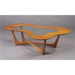 Coffee table with amoeba-shaped walnut top inset with plate glass on X-shaped streamline base. Un...