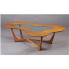 Image 1 : Coffee table with amoeba-shaped walnut top inset with plate glass on X-shaped streamline base. Un...