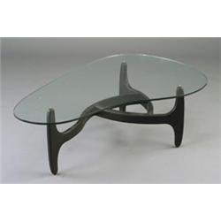 Walnut coffee table in the style of Vladimir Kagan, with biomorphic 1/2" plate glass top on eboni...